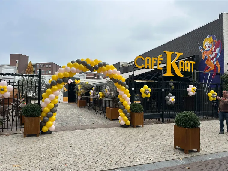Zwart-gouden ballonbogen bij een evenement